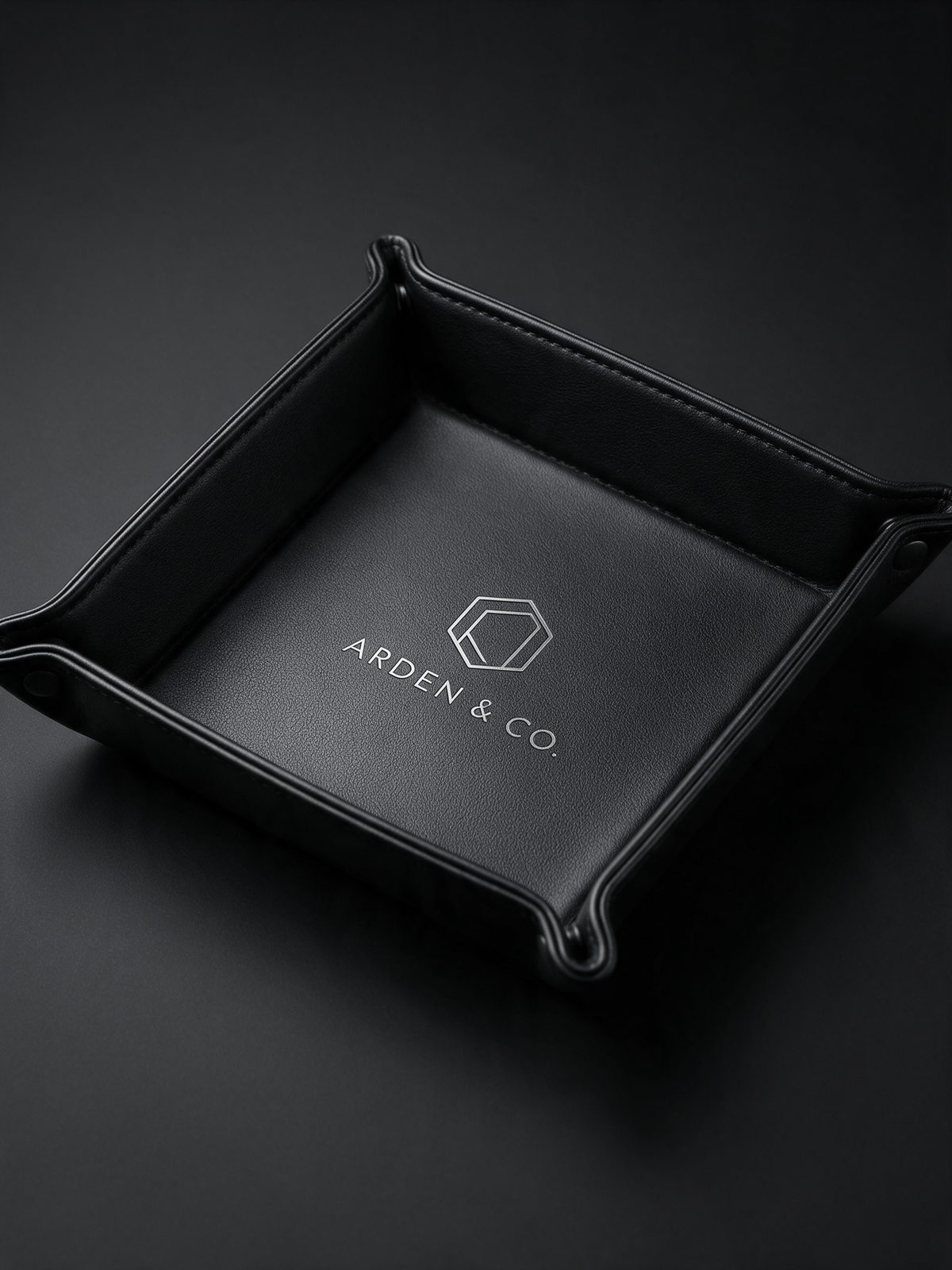 black leatherette valet tray laser engraved with a logo