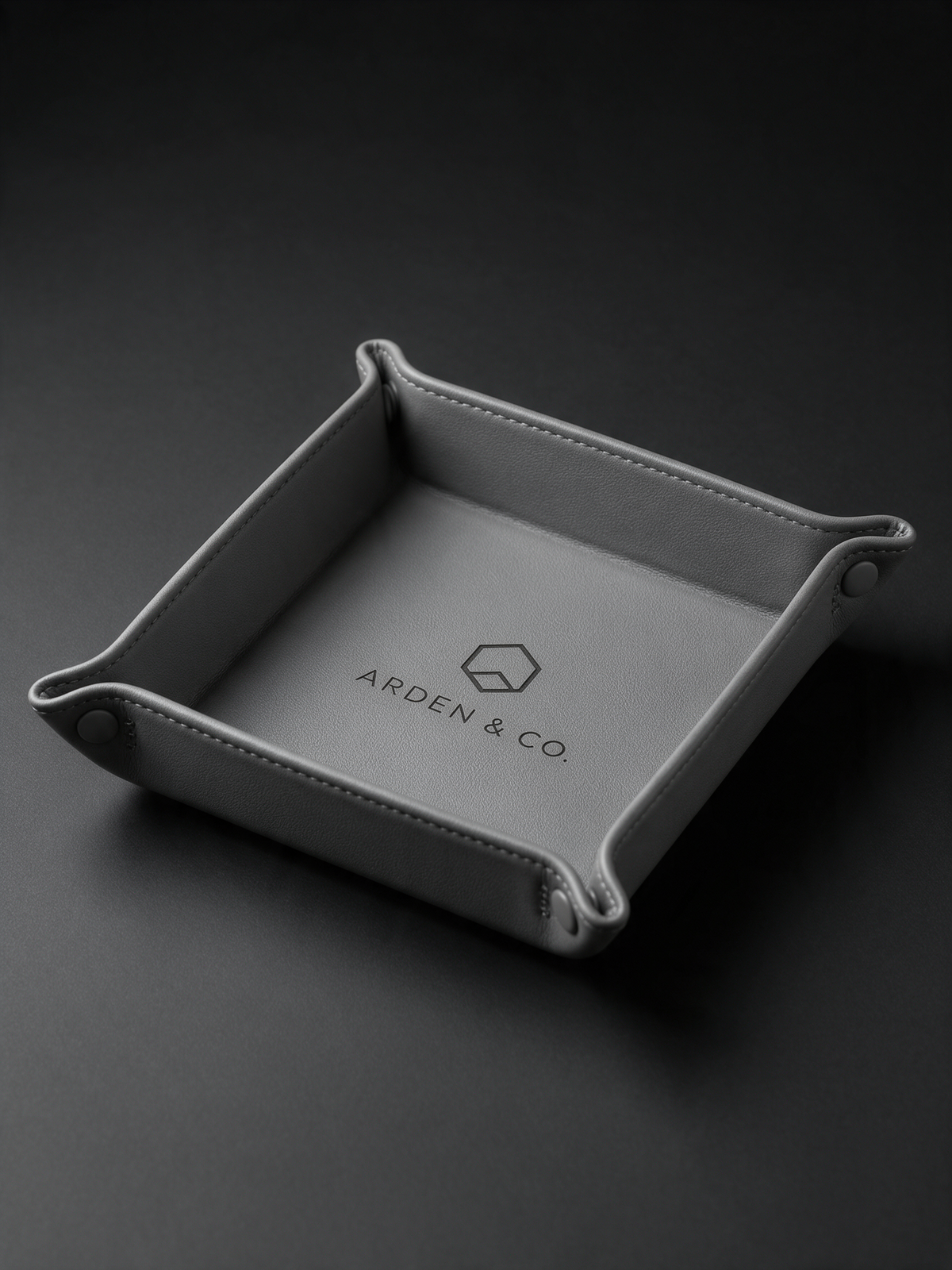 gray leatherette valet tray laser engraved with a logo
